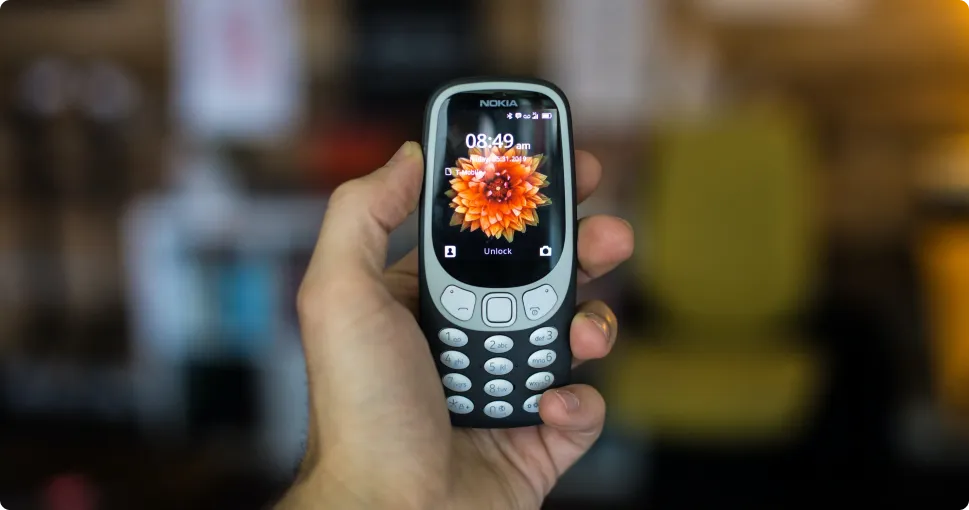 a man holding a mobile phone in hand